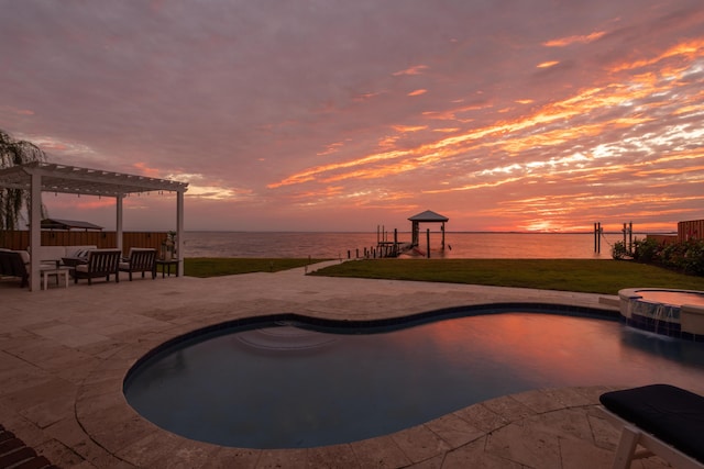 pool at dusk featuring a lawn, a pergola, a water view, and a patio