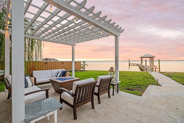 view of patio featuring a water view, an outdoor living space with a fire pit, a pergola, and boat lift