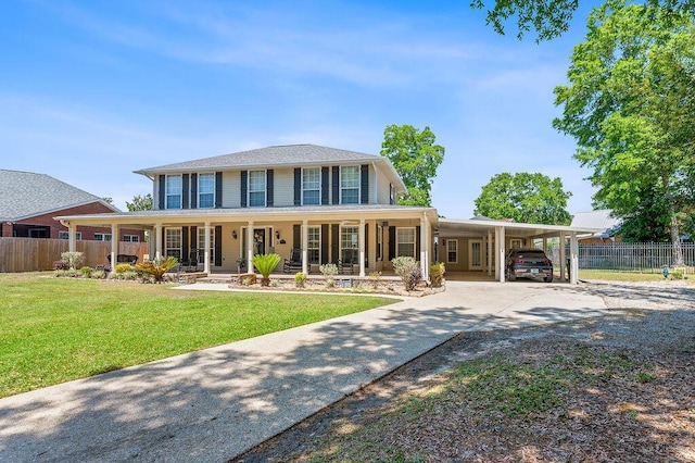 farmhouse-style home featuring a front lawn, fence, concrete driveway, a porch, and a carport