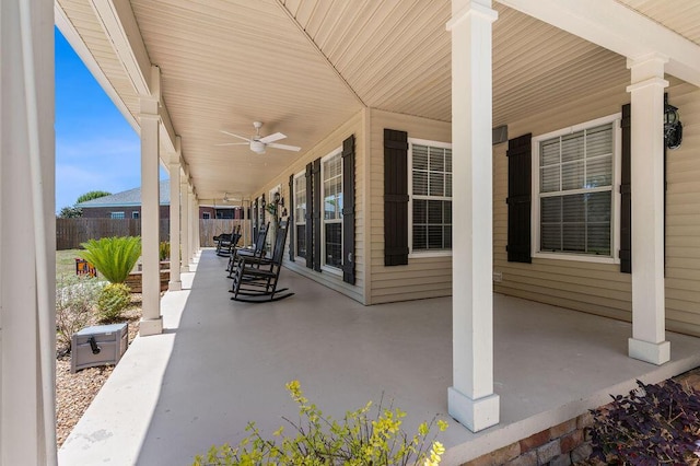 view of patio / terrace with a porch, ceiling fan, and fence