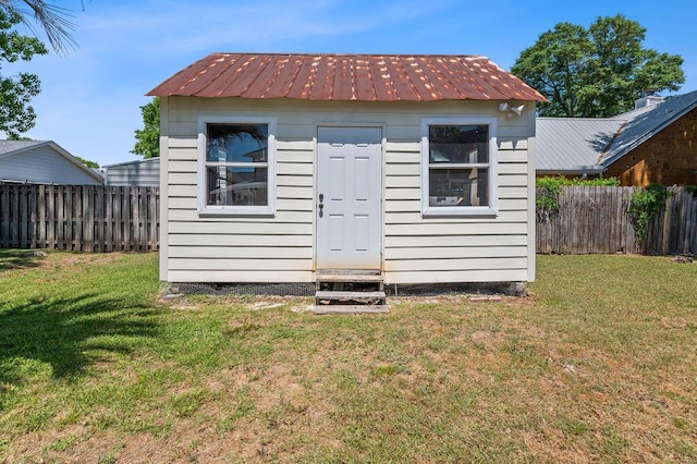 view of shed featuring entry steps and a fenced backyard