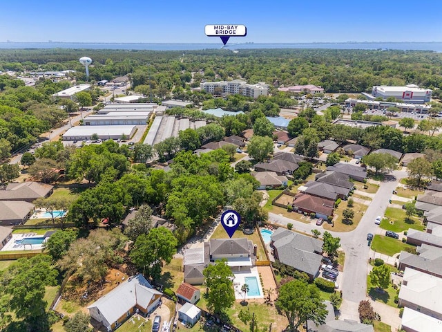 drone / aerial view featuring a view of trees and a residential view