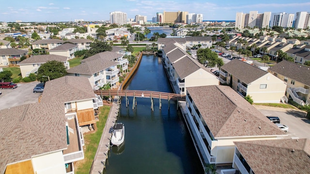 drone / aerial view featuring a city view and a water view