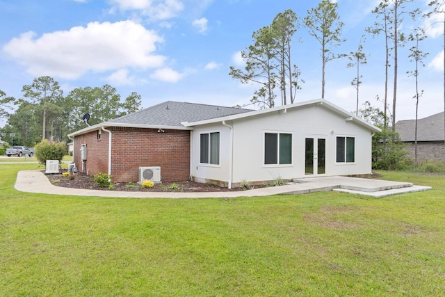 back of house featuring a lawn, a shingled roof, french doors, and ac unit