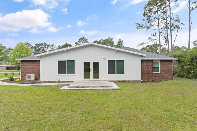 rear view of house with a patio, ac unit, a yard, french doors, and brick siding