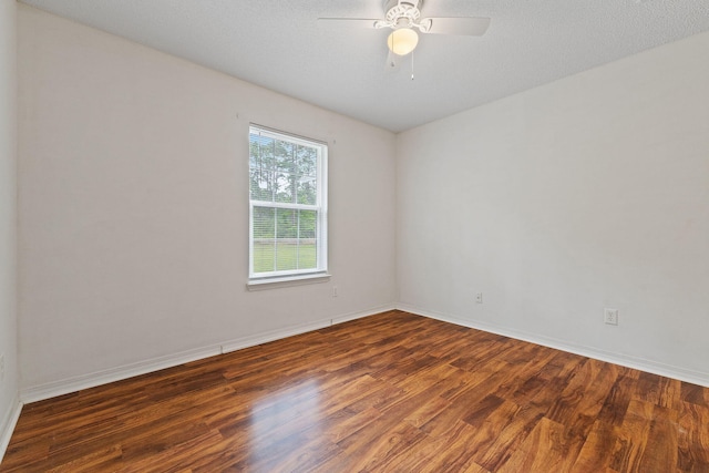 unfurnished room featuring a ceiling fan, wood finished floors, and baseboards