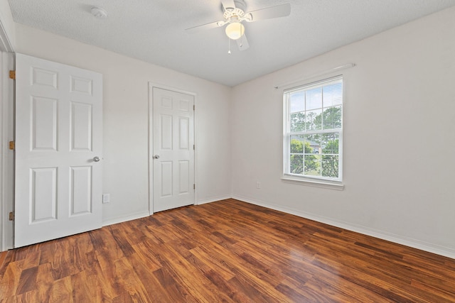 unfurnished bedroom featuring ceiling fan, wood finished floors, and baseboards