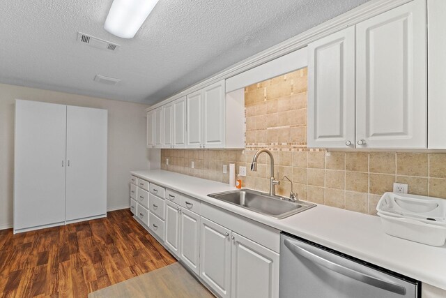 kitchen with visible vents, dishwasher, white cabinets, and a sink