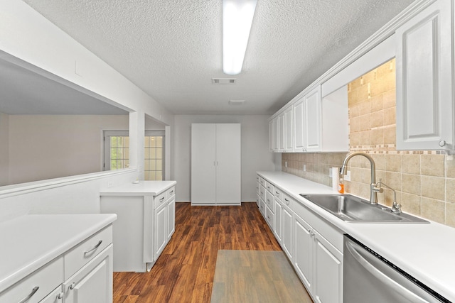 kitchen featuring light countertops, white cabinets, dishwasher, a sink, and visible vents