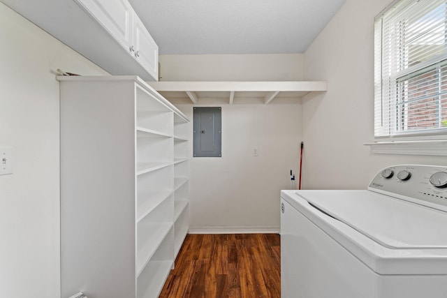 clothes washing area featuring electric panel, dark wood-style flooring, washer / clothes dryer, and cabinet space