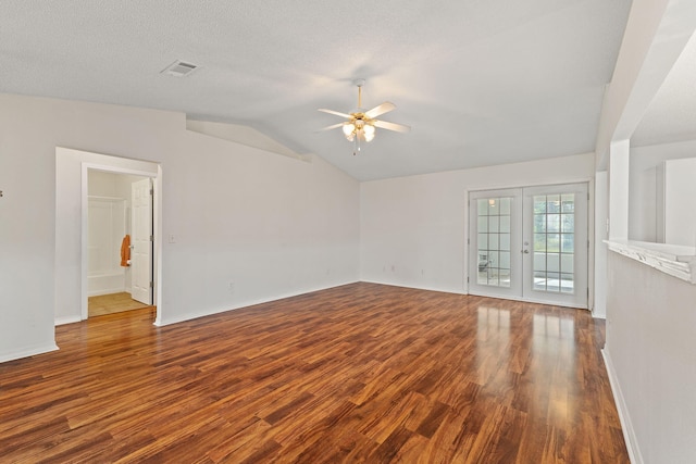 unfurnished living room featuring wood finished floors, vaulted ceiling, ceiling fan, baseboards, and visible vents