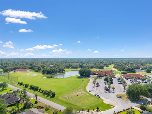drone / aerial view with golf course view and a water view
