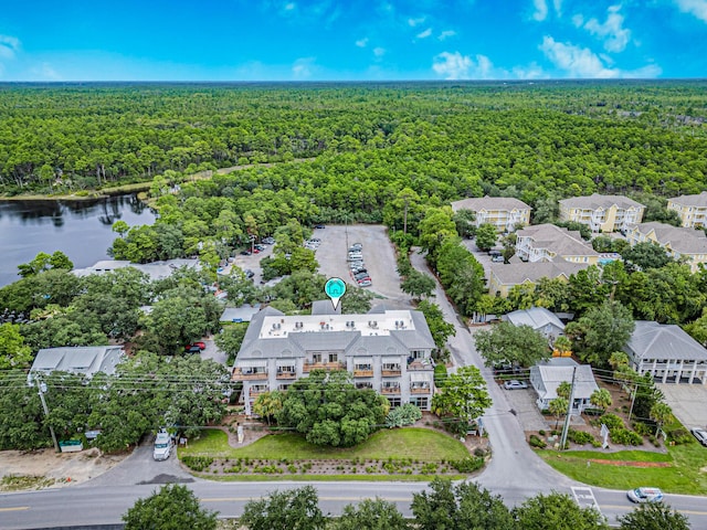 bird's eye view with a wooded view and a water view