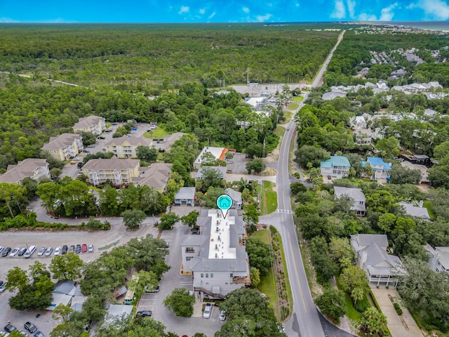 birds eye view of property featuring a forest view