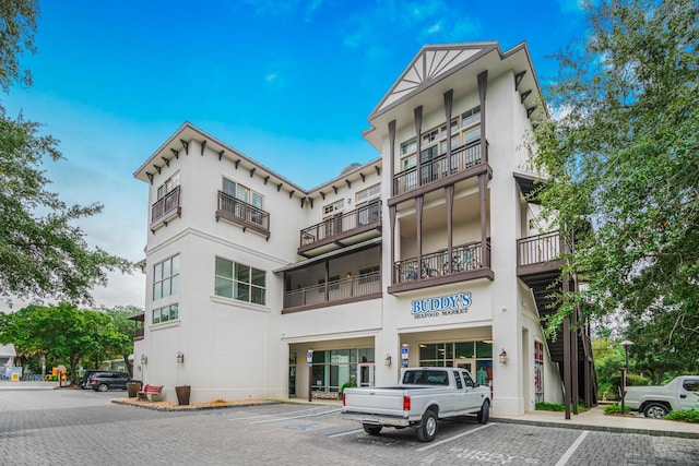 view of building exterior featuring uncovered parking