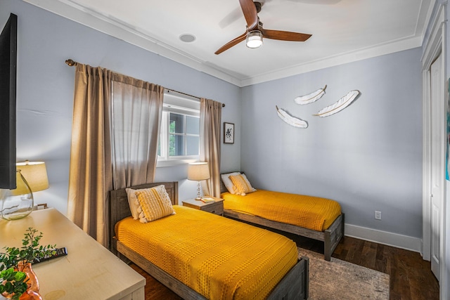 bedroom with crown molding, ceiling fan, wood finished floors, and baseboards