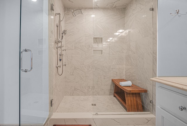 bathroom featuring a stall shower and vanity