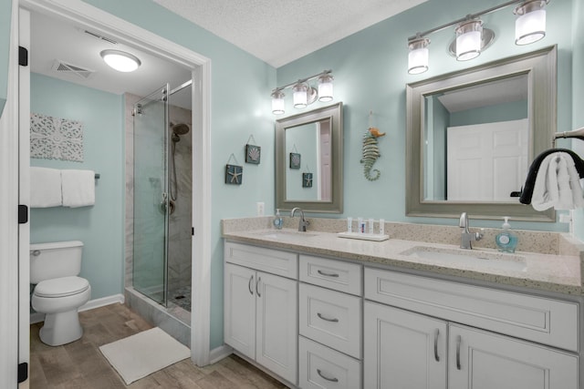 1160 Scenic Gulf Dr Unit 204A, Miramar Beach, FL 32550 - bathroom featuring visible vents, a sink, wood finished floors, and toilet