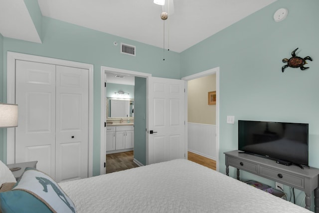 1160 Scenic Gulf Dr Unit 204A, Miramar Beach, FL 32550 - bedroom featuring visible vents, wood finished floors, a sink, a closet, and ensuite bathroom
