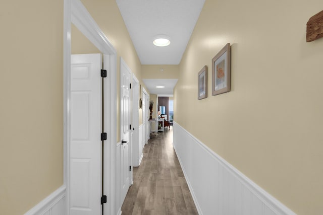 1160 Scenic Gulf Dr Unit 204A, Miramar Beach, FL 32550 - hallway with a wainscoted wall and light wood finished floors