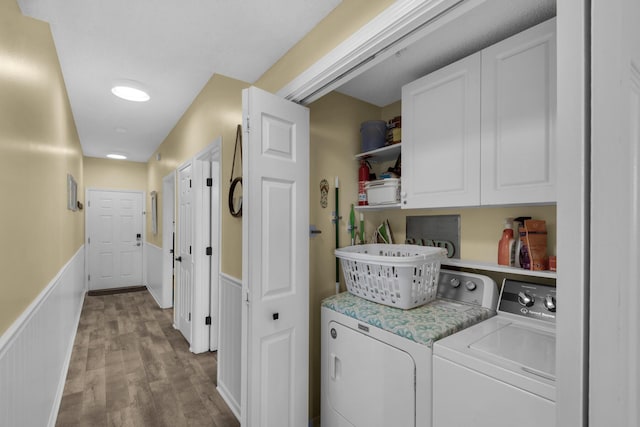1160 Scenic Gulf Dr Unit 204A, Miramar Beach, FL 32550 - laundry room with a wainscoted wall, wood finished floors, cabinet space, and washer and dryer