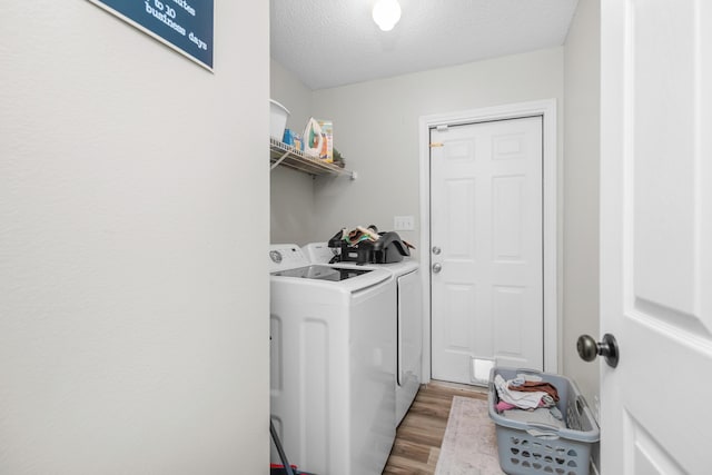 1207 Jefferyscot Dr, Crestview, FL 32536 - laundry room with light wood-type flooring, a textured ceiling, washer and clothes dryer, and laundry area