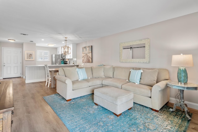 51 Cross Creek Rd Unit 15, Miramar Beach, FL 32550 - living room featuring visible vents, an inviting chandelier, light wood-style flooring, and baseboards