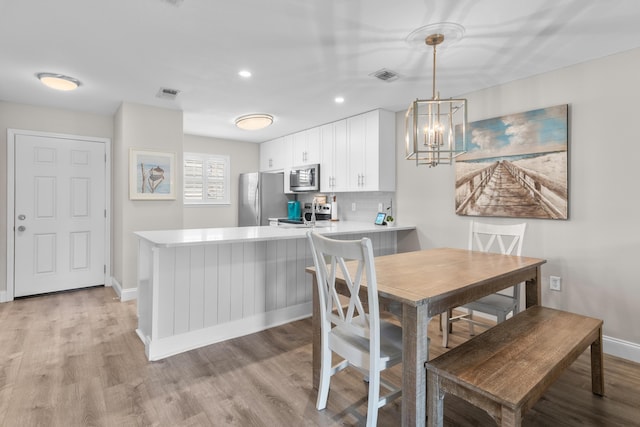 51 Cross Creek Rd Unit 15, Miramar Beach, FL 32550 - dining area featuring recessed lighting, an inviting chandelier, light wood-type flooring, baseboards, and visible vents