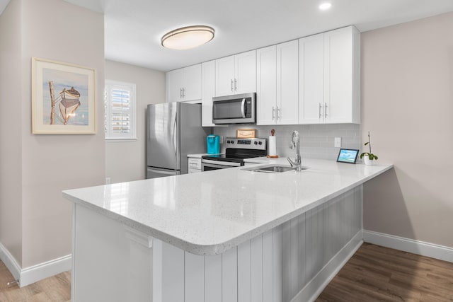 51 Cross Creek Rd Unit 15, Miramar Beach, FL 32550 - kitchen featuring appliances with stainless steel finishes, light stone counters, baseboards, and a sink
