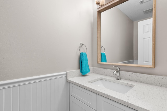 51 Cross Creek Rd Unit 15, Miramar Beach, FL 32550 - bathroom with visible vents, a wainscoted wall, and vanity