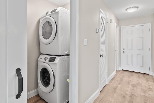 51 Cross Creek Rd Unit 15, Miramar Beach, FL 32550 - laundry area with stacked washer and dryer, light wood finished floors, laundry area, and baseboards