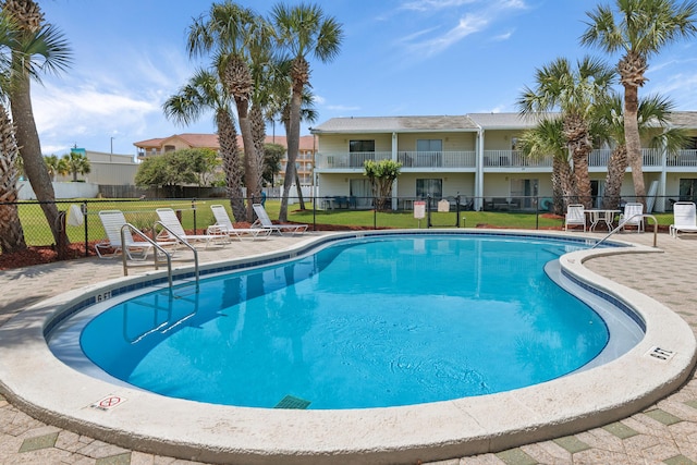 51 Cross Creek Rd Unit 15, Miramar Beach, FL 32550 - community pool with a lawn, a patio area, and fence