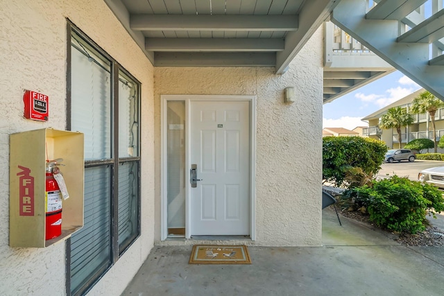 property entrance featuring stucco siding