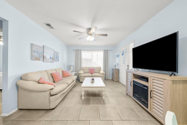living area with light tile patterned flooring, ceiling fan, and visible vents
