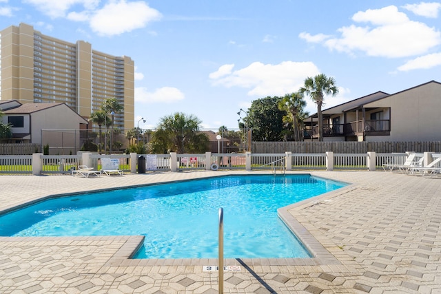 pool featuring a patio and fence