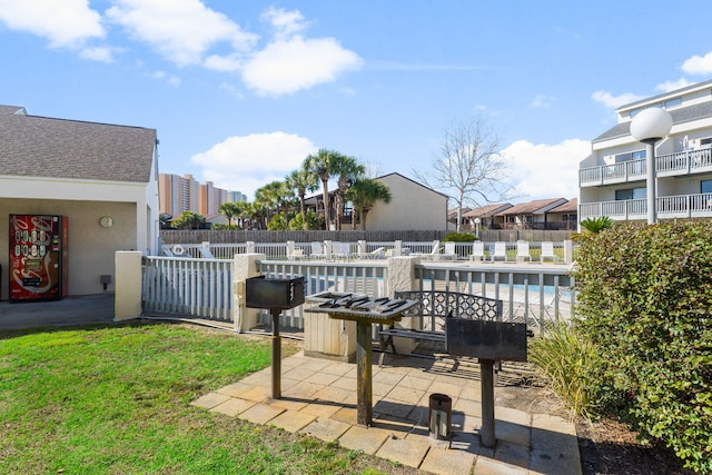 view of patio / terrace featuring fence and a community pool