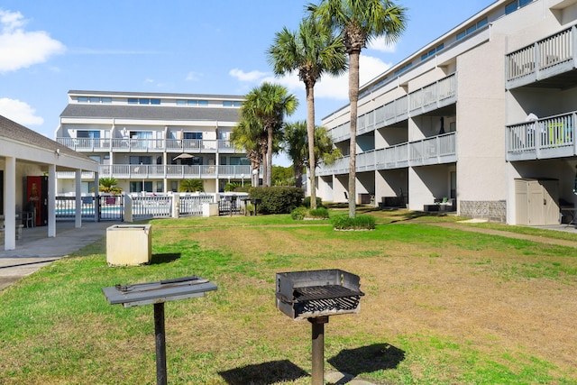 view of home's community featuring fence and a lawn