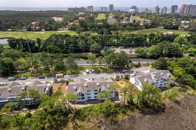 birds eye view of property with a city view, a water view, and view of golf course