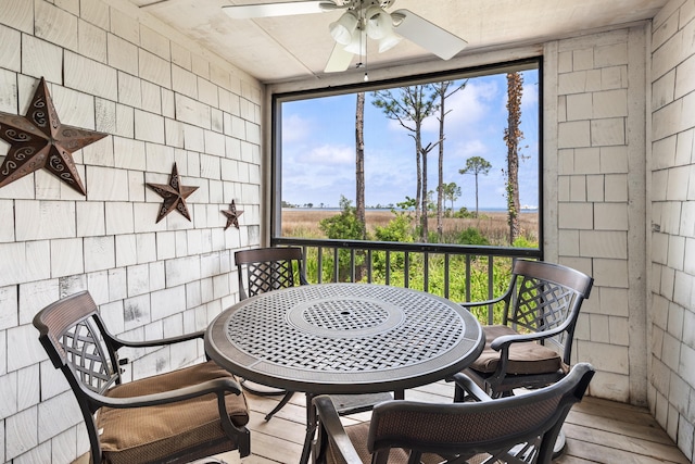 sunroom featuring outdoor dining space and ceiling fan