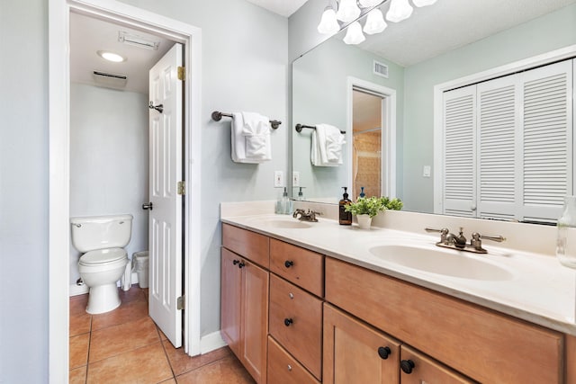 bathroom with tile patterned floors, visible vents, and a sink