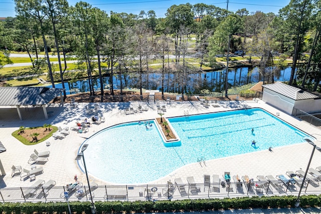 pool featuring a water view and fence