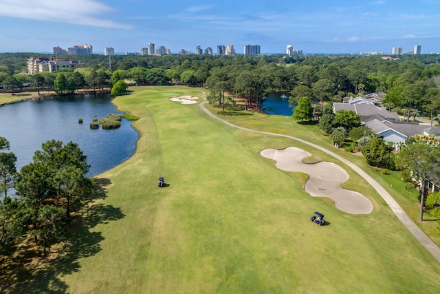birds eye view of property with view of golf course, a water view, and a city view
