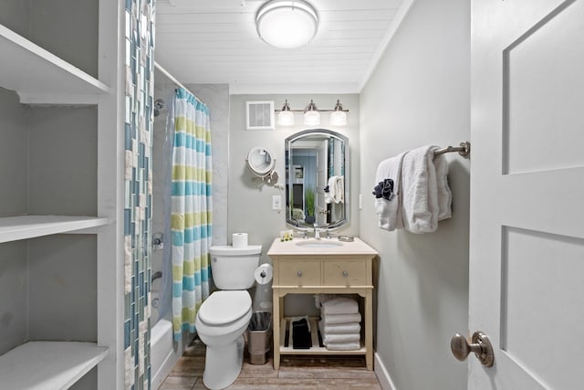 bathroom featuring vanity, toilet, visible vents, baseboards, and wood finished floors