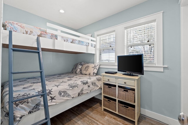 bedroom with baseboards and wood finished floors