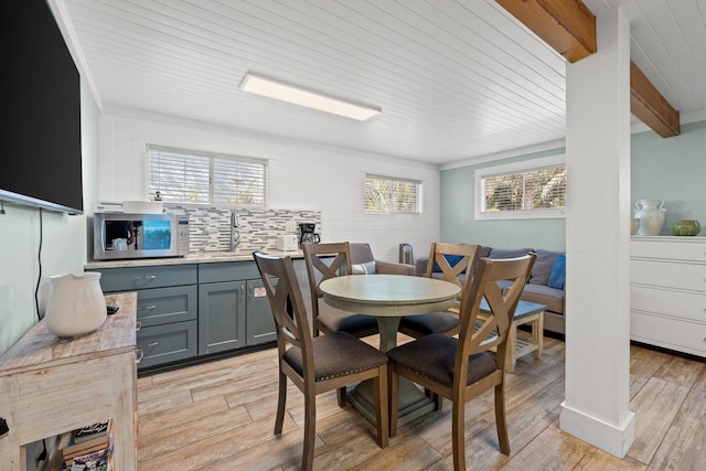 dining area featuring light wood-type flooring and wood ceiling