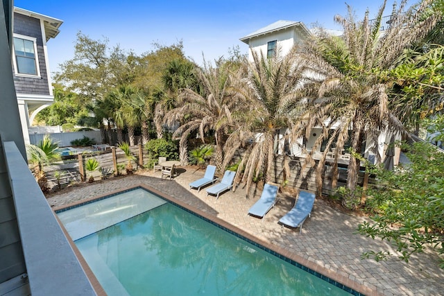 view of swimming pool with fence, a fenced in pool, and a patio area
