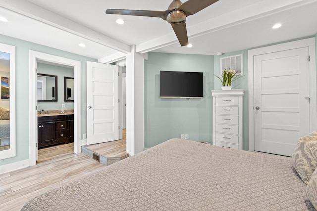 bedroom featuring light wood-style floors, connected bathroom, recessed lighting, and beamed ceiling