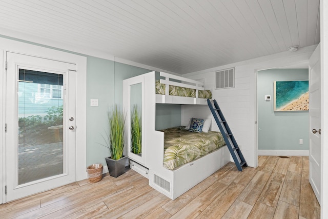 bedroom featuring visible vents, light wood-style flooring, and wooden ceiling