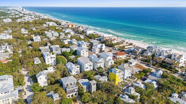 drone / aerial view featuring a view of the beach, a residential view, and a water view