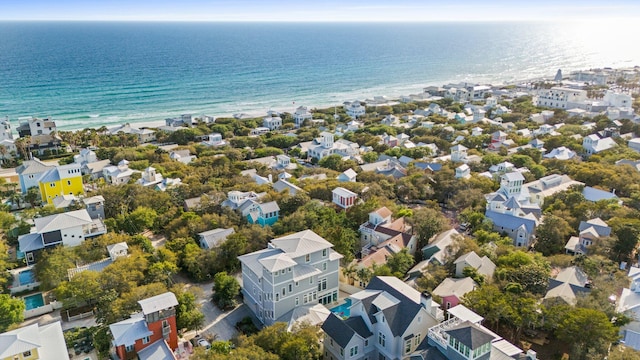 drone / aerial view featuring a residential view, a view of the beach, and a water view
